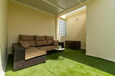 a living room with a couch and a table at Allo Apartments Ático Jaramago Parking Centro 1 Hab in Jerez de la Frontera