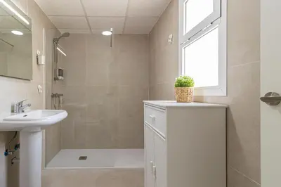a bathroom with a sink and a shower and a sink at Allo Apartments Ático Jaramago Parking Centro 1 Hab in Jerez de la Frontera