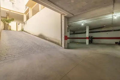 an empty parking garage with a brick floor at Allo Apartments Ático Jaramago Parking Centro 1 Hab in Jerez de la Frontera