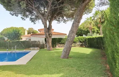 a house with a swimming pool and two trees at Urbanización Pinar de Roche 2 in Conil de la Frontera