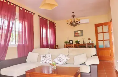 a living room with a couch and a table at Urbanización Pinar de Roche 2 in Conil de la Frontera