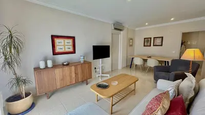 a living room with a couch and a table at SIBS ELPUERTO - SANCIRO Ideal Familias Piscina Parking in El Puerto de Santa María
