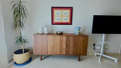 a room with a wooden cabinet and a plant at SIBS ELPUERTO - SANCIRO Ideal Familias Piscina Parking in El Puerto de Santa María