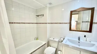a bathroom with a sink and a toilet and a bath tub at SIBS ELPUERTO - SANCIRO Ideal Familias Piscina Parking in El Puerto de Santa María