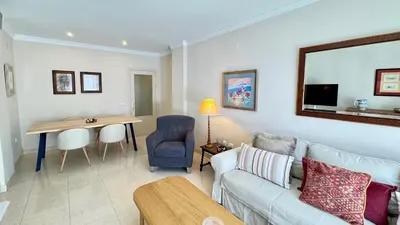 a living room with a couch and a table at SIBS ELPUERTO - SANCIRO Ideal Familias Piscina Parking in El Puerto de Santa María