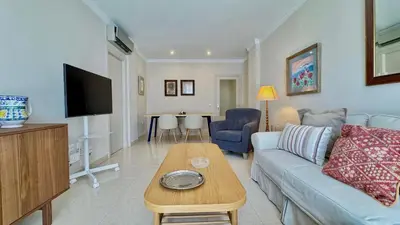 a living room with a couch and a table at SIBS ELPUERTO - SANCIRO Ideal Familias Piscina Parking in El Puerto de Santa María