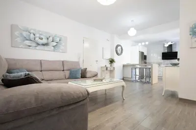 a living room with a couch and a table at Royal Rent Sanlúcar Cerro Falón in Sanlúcar de Barrameda