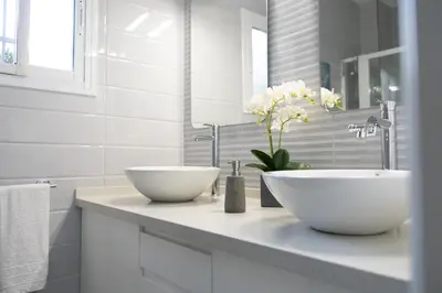 a bathroom with two white sinks on a counter at Royal Rent Sanlúcar Cerro Falón in Sanlúcar de Barrameda