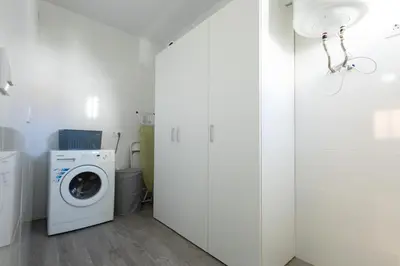 a white laundry room with a washer and dryer at Royal Rent Sanlúcar Cerro Falón in Sanlúcar de Barrameda