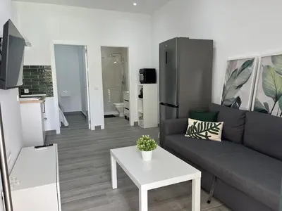 a living room with a couch and a table at Apartamentos Sayonara Beach 1 in Sanlúcar de Barrameda