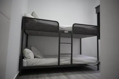 a bedroom with two bunk beds in a room at Apartamentos Sayonara Beach 1 in Sanlúcar de Barrameda