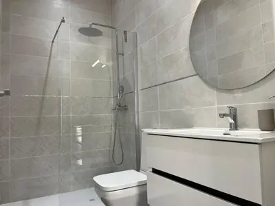 a bathroom with a shower and a toilet and a sink at Apartamentos Sayonara Beach 1 in Sanlúcar de Barrameda