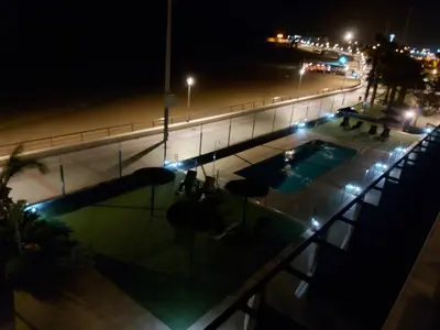a view of a swimming pool at night at Casa deI Mar Chipiona II in Chipiona