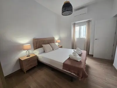 a bedroom with a bed with two towels on it at Allo Apartments Campana Centro 2 Habitaciones in Jerez de la Frontera