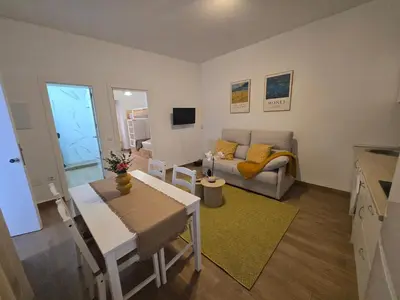 a living room with a table and a couch at Allo Apartments Campana Centro 2 Habitaciones in Jerez de la Frontera