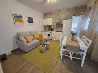 a kitchen and living room with a table and a couch at Allo Apartments Campana Centro 2 Habitaciones in Jerez de la Frontera
