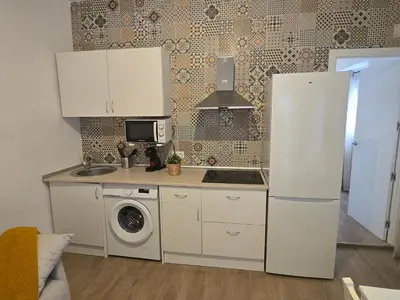 a kitchen with a refrigerator and a washing machine at Allo Apartments Campana Centro 2 Habitaciones in Jerez de la Frontera