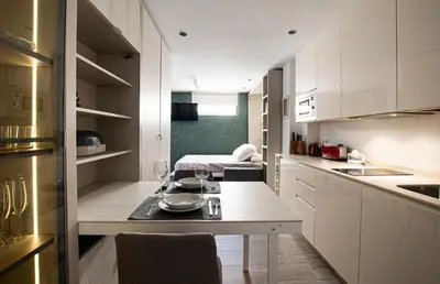 a small kitchen with a table with wine glasses on it at Apartamento Las 3 Terrazas in Cádiz