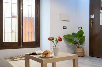 a coffee table with a plate of bread on it at CDZ - Bella in Cádiz