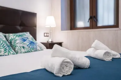 a hotel room with towels on a bed at CDZ - Bella in Cádiz