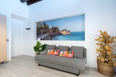 a living room with a couch and a painting on the wall at CDZ - Bella in Cádiz
