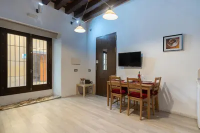 a dining room with a table and chairs and a television at CDZ - Bella in Cádiz