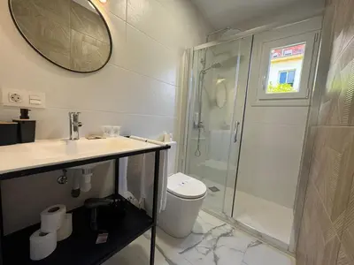 a bathroom with a shower and a toilet and a sink at Apartamento Santo Tomas Grupo AC Gestion in Cádiz