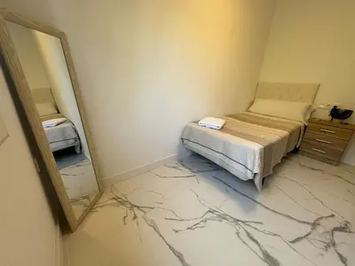 a bedroom with a bed and a mirror at Apartamento Santo Tomas Grupo AC Gestion in Cádiz