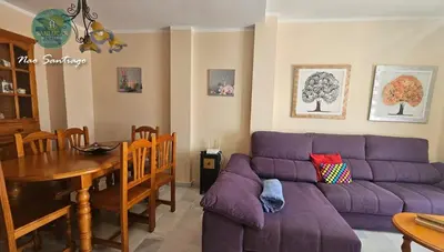 a living room with a purple couch and a table at Nao Santiago by Sanlúcar Housing in Sanlúcar de Barrameda
