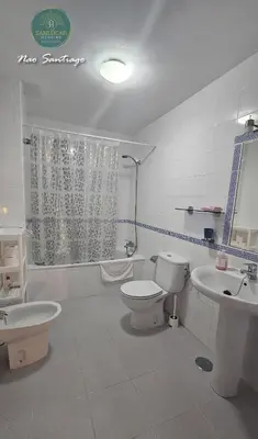 a white bathroom with a toilet and a sink at Nao Santiago by Sanlúcar Housing in Sanlúcar de Barrameda