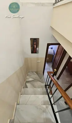 a staircase in a room with a painting on the wall at Nao Santiago by Sanlúcar Housing in Sanlúcar de Barrameda