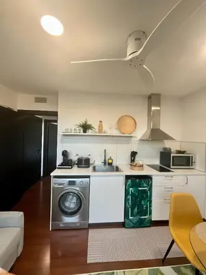 a kitchen with a washing machine and a sink at Puesta de Sol Doñana Adults Only in Sanlúcar de Barrameda