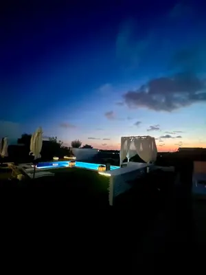 a view of a swimming pool at night at Puesta de Sol Doñana Adults Only in Sanlúcar de Barrameda