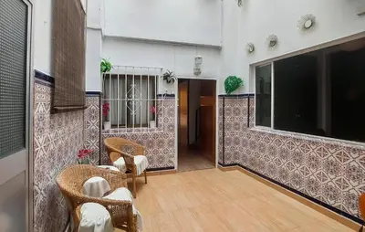 a room with chairs and tables and a building at Nice Home In Jerez De La Frontera in Jerez de la Frontera