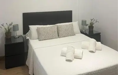 a bedroom with a white bed with towels on it at Nice Home In Jerez De La Frontera in Jerez de la Frontera