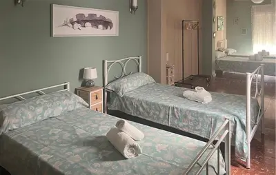 a bedroom with two beds with towels on them at Nice Home In Jerez De La Frontera in Jerez de la Frontera
