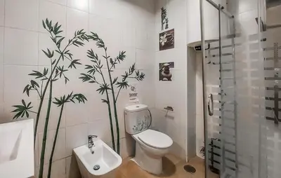a bathroom with a toilet and a plant on the wall at Nice Home In Jerez De La Frontera in Jerez de la Frontera