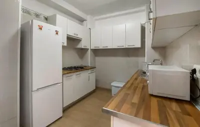 a kitchen with white cabinets and a white refrigerator at Nice Home In Jerez De La Frontera in Jerez de la Frontera