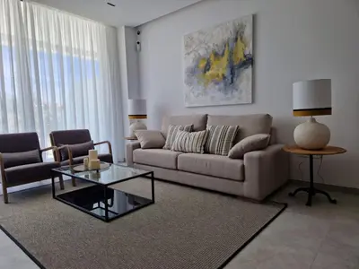 a living room with a couch and a glass table at ELEVENLIGHTS-COSTABALLENA Garden View in Costa Ballena