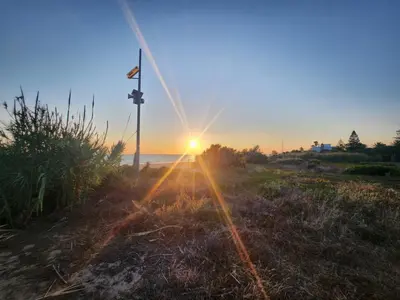 a sunset over the ocean with the sun setting at ELEVENLIGHTS-COSTABALLENA Garden View in Costa Ballena