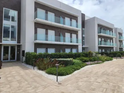 an apartment building with a courtyard in front of it at ELEVENLIGHTS-COSTABALLENA Garden View in Costa Ballena