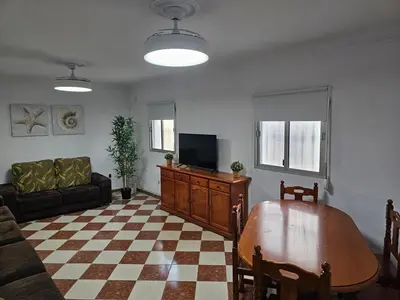 a living room with a couch and a table at La Casita in Chiclana de la Frontera