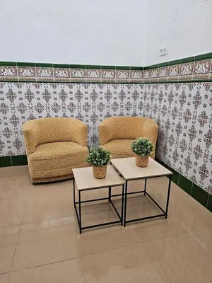 two chairs and two tables in a room at La Casita in Chiclana de la Frontera