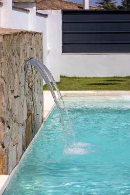 a water fountain in a swimming pool at Montijo Relax and Sunny Private Pool in Cádiz