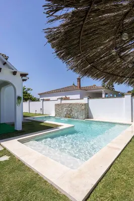 a swimming pool in front of a villa at Montijo Relax and Sunny Private Pool in Cádiz