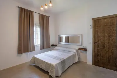 a bedroom with a bed and a window and a door at Montijo Relax and Sunny Private Pool in Cádiz