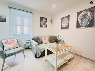 a living room with a couch and a table at Viña Coqueta Grupo AC Gestion in Cádiz