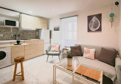 a living room with a couch and a table at Viña Coqueta Grupo AC Gestion in Cádiz