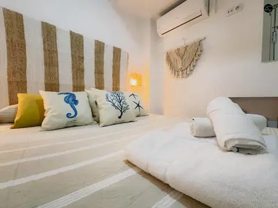 a room with two beds with pillows on them at Viña Coqueta Grupo AC Gestion in Cádiz