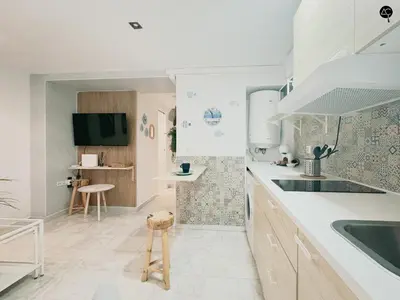 a white kitchen with a sink and a counter at Viña Coqueta Grupo AC Gestion in Cádiz